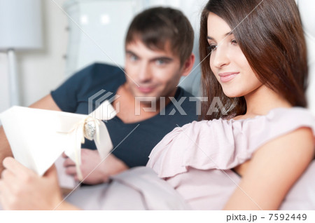 Closeup portrait of a happy young couple relaxing on the bed. Ma Closeup portrait of a happy young couple relaxing on the bed. Ma 7592449