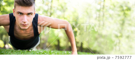 Full length of young man full of attitude doing pushups on grass Full length of young man full of attitude doing pushups on grass 7592777