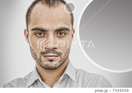 Portrait of adult businessman posing against grey background. Bl 7593059