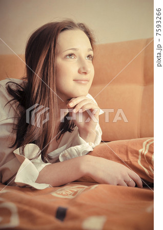 Closeup portrait of young pretty girl laying on her bed Closeup portrait of young pretty girl laying on her bed 7593266