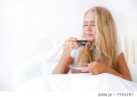 Closeup portrait of a pretty young female having a cup of coffee 7593287