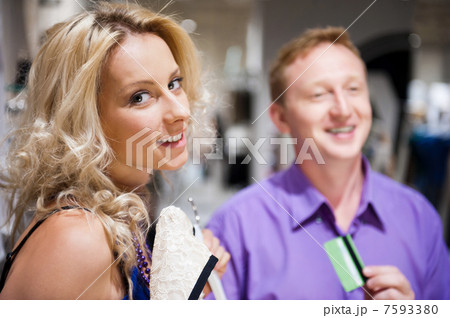 Young attractive happy couple shopping at mall. Young attractive happy couple shopping at mall. 7593380