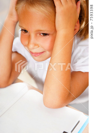 Image of smart child reading interesting book in classroom Image of smart child reading interesting book in classroom 7593398