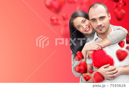 Beautiful young couple embracing and looking at camera. Standing Beautiful young couple embracing and looking at camera. Standing 7593626