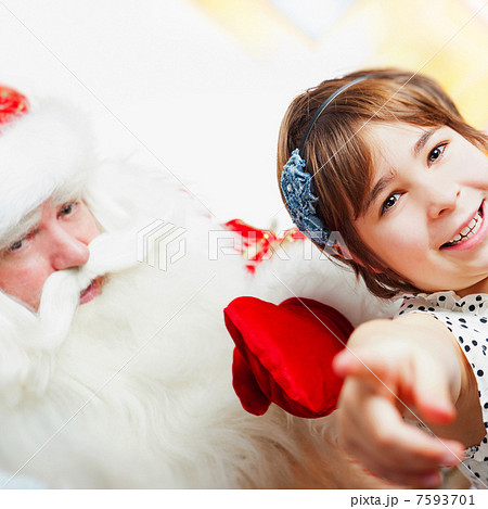 Christmas theme: Santa Claus and little girl having a fun. Indoo 7593701