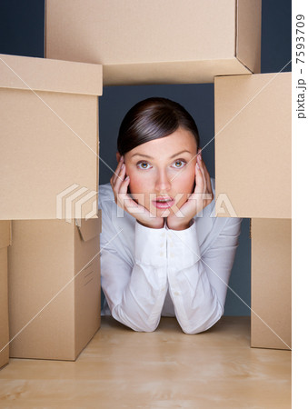 Portrait of young woman surrounded by lots of boxes. Lots of wor 7593709