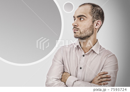 Portrait of adult businessman posing against grey background. Bl 7593724