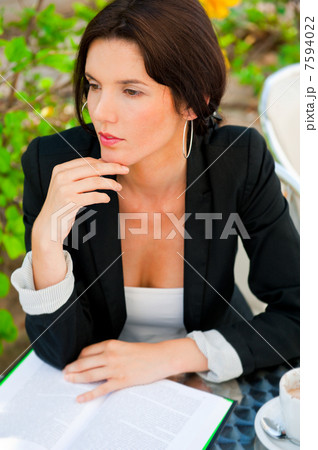 Portrait of a young attractive business woman sitting at outdoor 7594022