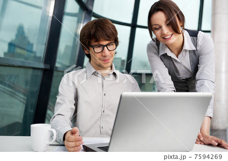 Portrait of confident business man explaining a project to colle 7594269