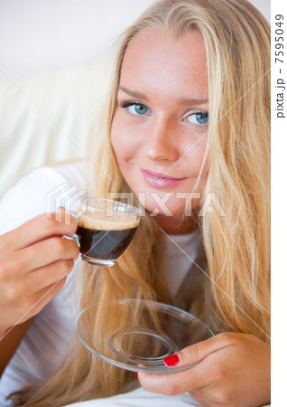 Closeup portrait of a pretty young female having a cup of coffee 7595049