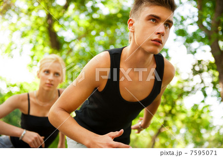 Closeup Portrait of Young Couple Jogging In Park Closeup Portrait of Young Couple Jogging In Park 7595071