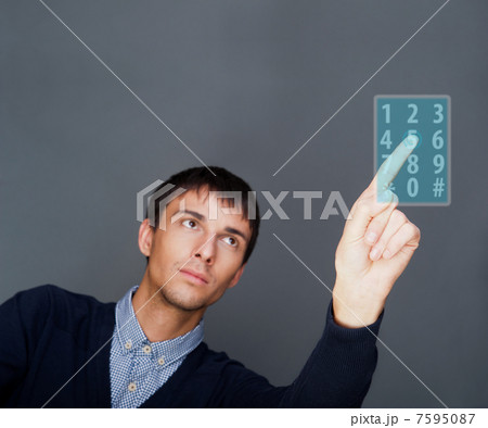 Portrait of adult business man pressing a touchscreen button whi 7595087