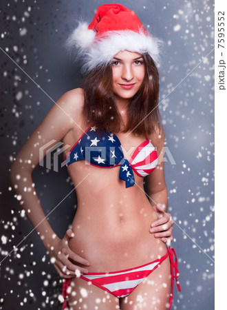 20-25 years old beautiful woman in christmas hat and swimsuit wi 20-25 years old beautiful woman in christmas hat and swimsuit wi 7595552