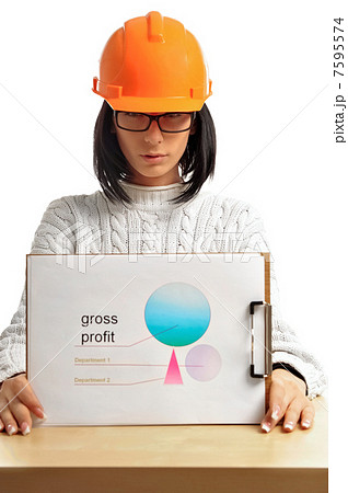 Young architect-woman wearing a protective helmet Young architect-woman wearing a protective helmet 7595574
