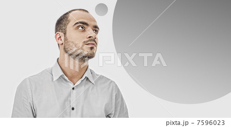 Portrait of adult businessman posing against grey background. Bl 7596023