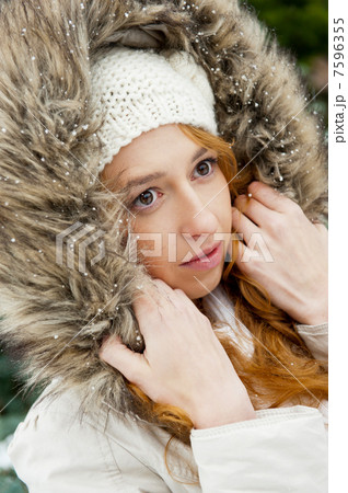 Portrait of pretty girl at winter background wearing warm clothe 7596355