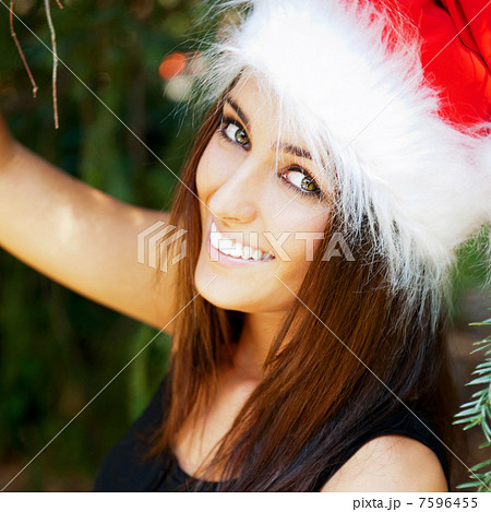 Portrait of a sexy young female smiling in a park and looking at 7596455