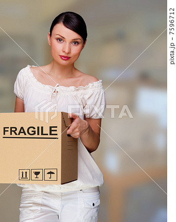 A woman holding a box inside office building or home interior. P A woman holding a box inside office building or home interior. P 7596712