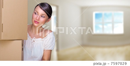 Smiling woman at her home holding boxes. She is Moving at her ne 7597029
