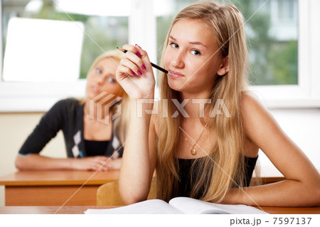 Portrait of a young group of students paying attention in class. 7597137