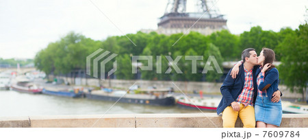 Romantic couple kissing near the Eiffel tower 7609784