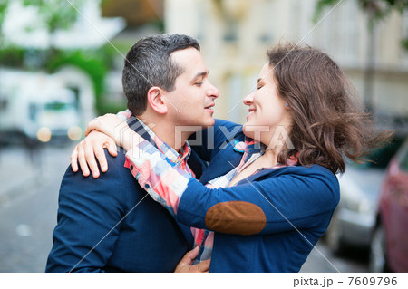 Happy couple looking at each other on the street Happy couple looking at each other on the street 7609796