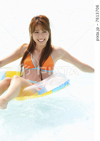 浮き輪で浮かぶ水着女性 7613706