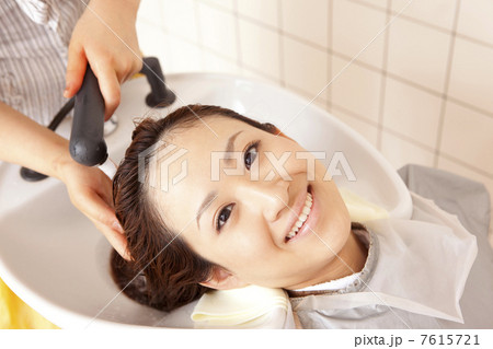 美容師に髪を洗ってもらう女性 7615721