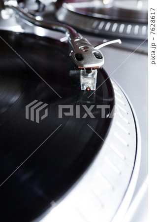Turntable playing vinyl record with music Turntable playing vinyl record with music 7628617