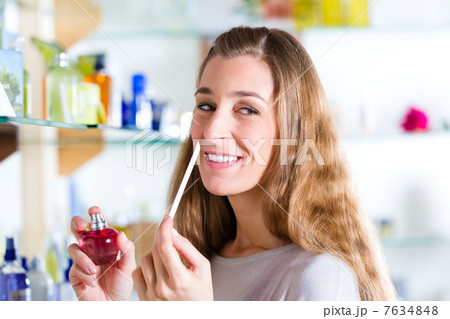 woman buying perfume in shop or store 7634848