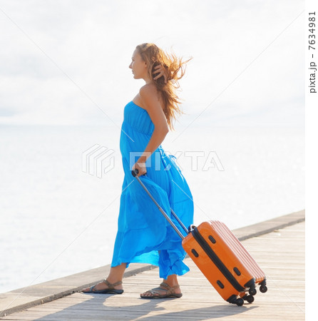 Young woman with suitcase on the pier Young woman with suitcase on the pier 7634981