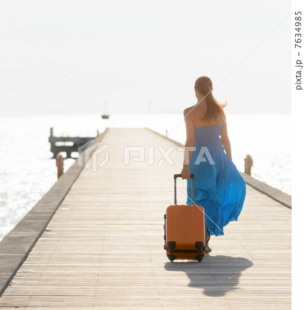 Young woman walking on wooden pier 7634985
