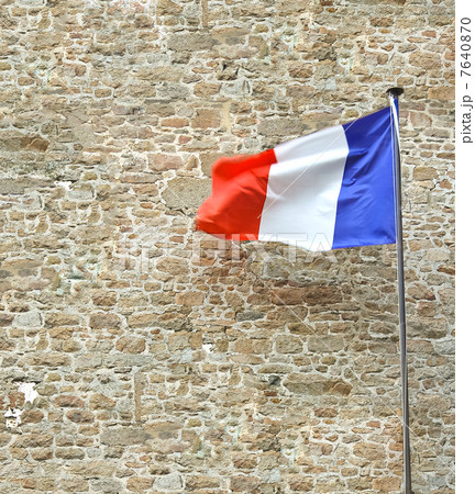 French flag near a stone fortress wall 7640870