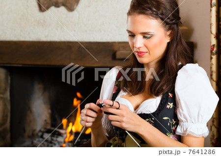 woman knitting in hunter's cabin or alpine hut 7641286