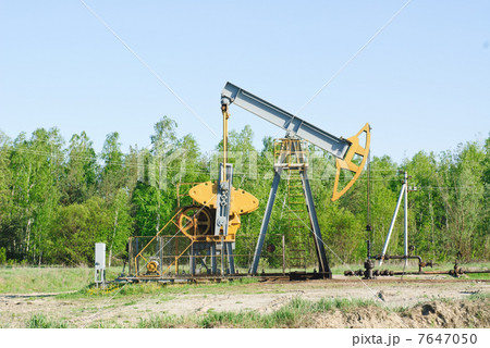 oil pump works on spring forest background oil pump works on spring forest background 7647050
