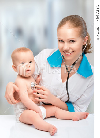 baby and doctor pediatrician. doctor listens to the heart with s 7647231