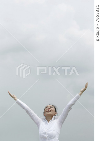 Young Asian woman with arms raised in celebration 7655321