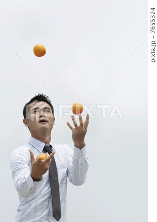 Asian Business man juggling Asian Business man juggling 7655324