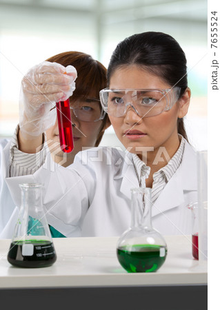 Two scientists analyzing solution. 7655524