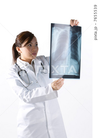 Portrait of a Female Doctor looking at an X-Ray. Portrait of a Female Doctor looking at an X-Ray. 7655539