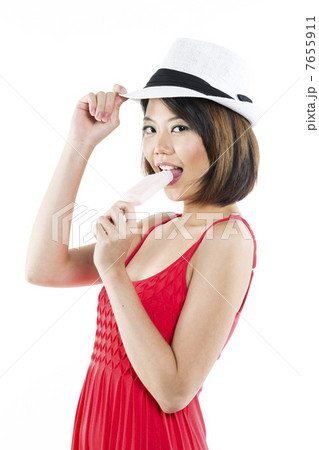Chinese woman eating ice lolly 7655911