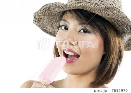 Chinese woman eating ice lolly Chinese woman eating ice lolly 7655976