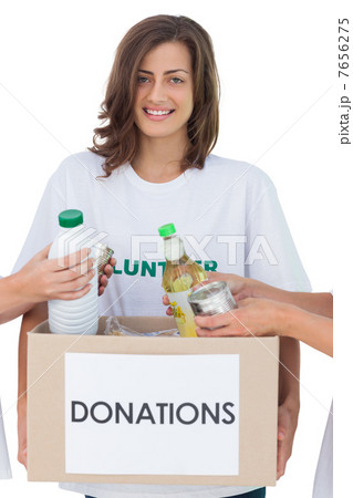 Smiling volunteer holding a food donation box 7656275