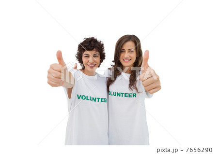 Two happy volunteers giving thumbs up Two happy volunteers giving thumbs up 7656290