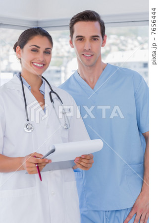 Doctor and surgeon smiling at the camera Doctor and surgeon smiling at the camera 7656444