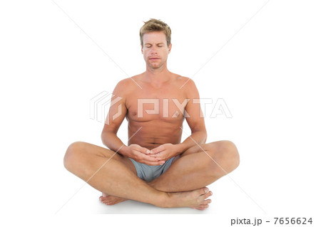 Man with eyes closed meditating on the floor 7656624