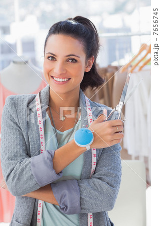 Attractive designer with measuring tape holding scissors 7656745