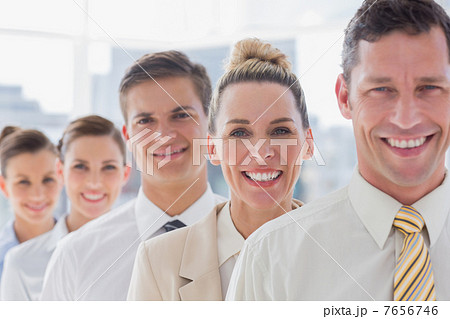 Smiling handsome businessman standing with his team 7656746