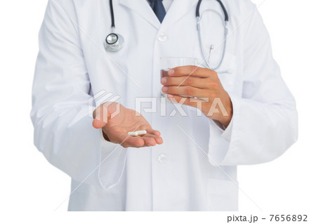 Doctor holding drugs and glass of water 7656892