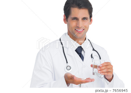 Happy doctor smiling and holding tablets and water 7656945
